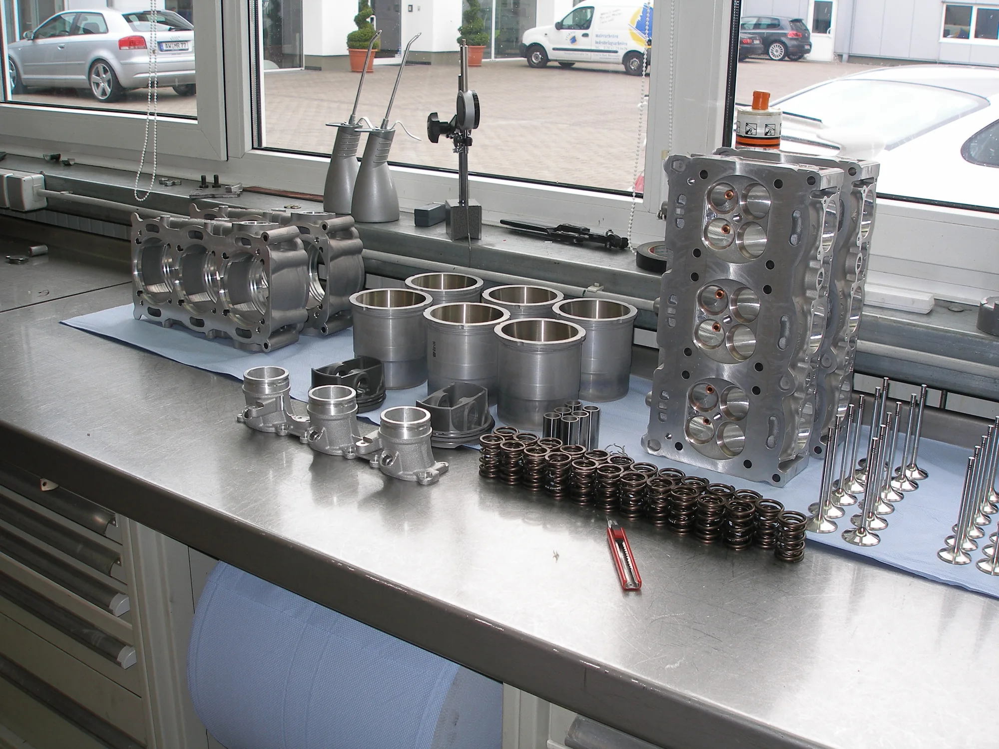Disassembled engine components arranged on a workshop bench
